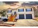 Inviting two-story home with a well-manicured lawn, two-car garage, and stylish entryway at 3280 Spincaster Way, Loganville, GA 30052