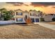 Charming two-story home with landscaped yard, two-car garage, and a welcoming entrance at 3280 Spincaster Way, Loganville, GA 30052