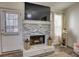 Modern living room with decorative fireplace, dark floors and door to exterior at 3280 Spincaster Way, Loganville, GA 30052