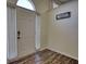 Light-filled foyer showcases dark floors, stylish door, and 'Gathering' decor at 3280 Spincaster Way, Loganville, GA 30052