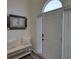 Bright foyer features a bench, picture, front door, and sleek floors at 3280 Spincaster Way, Loganville, GA 30052