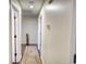 Hallway with neutral walls and wood flooring leading to bedrooms at 3280 Spincaster Way, Loganville, GA 30052