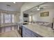 Open kitchen showcases granite countertops and stainless steel appliances overlooking the living area at 3280 Spincaster Way, Loganville, GA 30052