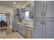 Modern kitchen features stainless steel appliances and stylish gray cabinetry at 3280 Spincaster Way, Loganville, GA 30052