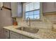 Bright kitchen features granite counters, stainless steel sink, and subway tile backsplash at 3280 Spincaster Way, Loganville, GA 30052