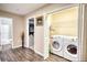 Open laundry room with washer, dryer, and wire shelving at 3280 Spincaster Way, Loganville, GA 30052