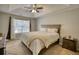 Bright main bedroom with tray ceiling, large window, and neutral color scheme at 3280 Spincaster Way, Loganville, GA 30052