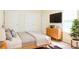 Bedroom with wood floors, a modern bed, dresser, flat screen TV and large window at 5352 Beaver Br, Norcross, GA 30071
