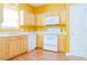 Well-lit kitchen with wood cabinets, white appliances and hardwood floors at 5352 Beaver Br, Norcross, GA 30071