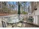 Cozy balcony with a table, chairs, and umbrella, offering a relaxing outdoor space at 1510 Gettysburg Pl, Atlanta, GA 30350