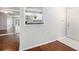 Light-filled entryway with hardwood floors, mirrored wall, and a view of the kitchen at 1510 Gettysburg Pl, Atlanta, GA 30350
