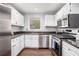Modern kitchen with white cabinets, stainless steel appliances, and granite countertops at 1510 Gettysburg Pl, Atlanta, GA 30350