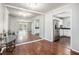 Open living space with hardwood floors, mirrored wall, and a view into the kitchen at 1510 Gettysburg Pl, Atlanta, GA 30350