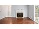 Living room with hardwood floors, fireplace, and a doorway to sunroom at 1510 Gettysburg Pl, Atlanta, GA 30350