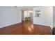 Open living area with hardwood floors, mirrored wall, and access to the kitchen at 1510 Gettysburg Pl, Atlanta, GA 30350