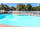 Community outdoor swimming pool surrounded by a white fence and lush green trees at 1510 Gettysburg Pl, Atlanta, GA 30350