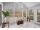 Sunroom filled with natural light from many windows and neutral tiled flooring at 1510 Gettysburg Pl, Atlanta, GA 30350