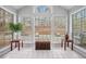 Sunroom with tiled flooring and large windows overlooking the surrounding greenery at 1510 Gettysburg Pl, Atlanta, GA 30350
