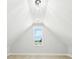 Finished attic with a vaulted ceiling, a modern light fixture, and a window with a view of the outside at 3057 Bold Springs Rd, Dacula, GA 30019