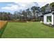 A lush backyard with a pristine lawn and a wooden fence for privacy and security at 3057 Bold Springs Rd, Dacula, GA 30019