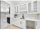 Stylish bar area with white cabinets, countertop, and wine rack offers an elegant space for entertaining at 3057 Bold Springs Rd, Dacula, GA 30019