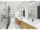 Bright bathroom with dual vanities, modern fixtures, and a glass-enclosed shower at 3057 Bold Springs Rd, Dacula, GA 30019