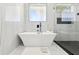Spa-like bathroom with a freestanding tub and a glass-enclosed shower at 3057 Bold Springs Rd, Dacula, GA 30019