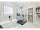 Spa-like bathroom with a freestanding tub and a glass-enclosed shower at 3057 Bold Springs Rd, Dacula, GA 30019