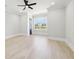 Neutral bedroom with a ceiling fan and a large window overlooking the backyard at 3057 Bold Springs Rd, Dacula, GA 30019