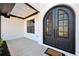 Close-up of a modern home's entryway featuring sleek black double doors and white brick at 3057 Bold Springs Rd, Dacula, GA 30019