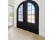 Close-up of black paneled double front doors leading to light wood flooring at 3057 Bold Springs Rd, Dacula, GA 30019