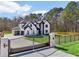 Stunning two-story home with a gated entrance, black trim, a three-car garage and a landscaped yard at 3057 Bold Springs Rd, Dacula, GA 30019