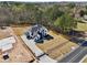 Drone view of new home with gated driveway and large yard still under construction at 3057 Bold Springs Rd, Dacula, GA 30019