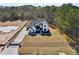 Aerial view of new construction home with gated driveway and expansive lawn space at 3057 Bold Springs Rd, Dacula, GA 30019
