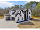 Striking two-story home with a three-car garage and beautifully landscaped front yard at 3057 Bold Springs Rd, Dacula, GA 30019