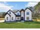 Beautiful two-story home with a well-manicured lawn, black trim, and modern design at 3057 Bold Springs Rd, Dacula, GA 30019