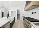 Modern kitchen featuring stainless steel appliances, a large island, and custom white cabinetry with a large walk-in pantry at 3057 Bold Springs Rd, Dacula, GA 30019