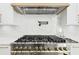 Gourmet kitchen featuring stainless steel appliances, including a professional-grade range and hood, with marble backsplash at 3057 Bold Springs Rd, Dacula, GA 30019