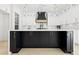 Detailed view of the kitchen island with a black cabinets, white countertop, and modern fixtures and hardware at 3057 Bold Springs Rd, Dacula, GA 30019