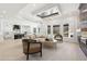 Bright, open living room featuring a modern chandelier, large windows, and seamless access to the kitchen at 3057 Bold Springs Rd, Dacula, GA 30019