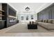 The virtually staged living room features fireplace, custom shelves, decorative trim, and natural light from large windows at 3057 Bold Springs Rd, Dacula, GA 30019