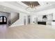 Open-concept living space featuring a grand staircase, modern lighting, and seamless flow to the stylish kitchen at 3057 Bold Springs Rd, Dacula, GA 30019