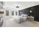 Luxurious main bedroom featuring elegant lighting, hardwood floors and bright windows at 3057 Bold Springs Rd, Dacula, GA 30019