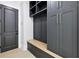 Organized mudroom featuring built-in cabinets, drawers, and a bench with dark gray accents at 3057 Bold Springs Rd, Dacula, GA 30019