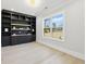 Office space with built-in shelving, storage cabinets, and a large window with backyard views at 3057 Bold Springs Rd, Dacula, GA 30019