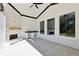 Covered patio with fireplace and kitchenette for outdoor entertaining at 3057 Bold Springs Rd, Dacula, GA 30019