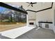 Covered outdoor patio with fireplace, outdoor kitchen, and view of the backyard at 3057 Bold Springs Rd, Dacula, GA 30019