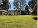 Large backyard with grassy lawn and mature trees offering plenty of room for recreation and relaxation at 546 Milligan Dr, Stone Mountain, GA 30083