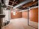 Unfinished basement with painted walls, support beams, and concrete flooring at 546 Milligan Dr, Stone Mountain, GA 30083