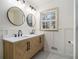 Beautiful bathroom with double sinks, modern lighting, and framed window at 546 Milligan Dr, Stone Mountain, GA 30083